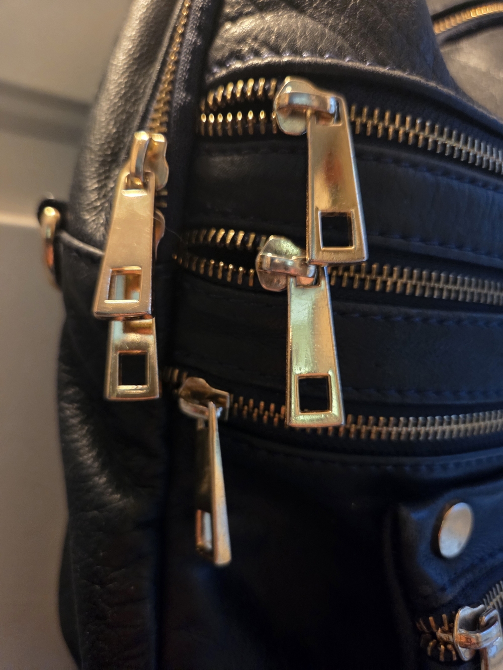 Women's Black Leather Backpack with Gold-Tone Zippers